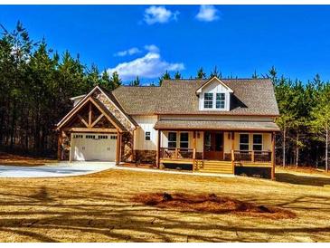 Inviting exterior view of the home, featuring a cozy front porch and attached garage at 136 Rainey Rd, Temple, GA 30179