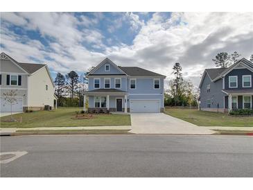 Charming two-story home featuring a manicured lawn, covered porch, and a two-car garage at 238 Arnewood Cir, Mcdonough, GA 30253