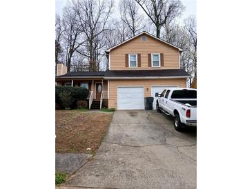 Charming two-story home with a two-car garage and a cozy front porch at 2760 Waterford Park Dr, Lawrenceville, GA 30044