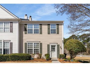 Charming two-story townhome featuring light siding, green shutters, and well-maintained landscaping at 1741 Stanwood Dr, Kennesaw, GA 30152