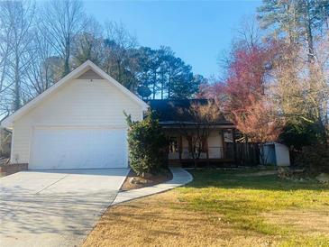Charming home featuring an attached two-car garage and well-maintained landscaping at 5206 Westhill Nw Dr, Norcross, GA 30071