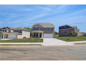 Beautiful new two-story home with a manicured lawn and a two car garage at 132 Dalston Cv, Stockbridge, GA 30281