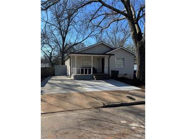 Charming home featuring a welcoming front porch and an expansive concrete driveway at 109 Thirkield Se Ave, Atlanta, GA 30315