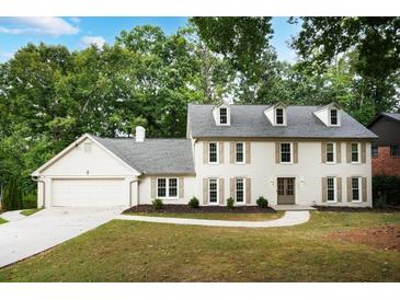 Beautiful two-story home boasts a well-manicured lawn and charming exterior details at 2958 Cravey Ne Dr, Atlanta, GA 30345