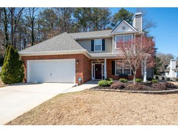 Charming two-story home featuring a brick facade, attached garage, and beautifully landscaped front yard at 3952 Rhyne Way, Smyrna, GA 30082