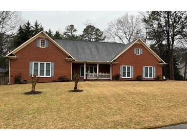 Charming single-story brick home with a cozy front porch and well-maintained lawn at 2151 Overland Way, Powder Springs, GA 30127