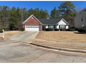 Well-maintained single-story home featuring a brick facade and an attached two-car garage at 50 Cold Springs Ct, Covington, GA 30016