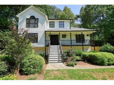 Charming home featuring a welcoming front porch and neatly landscaped front yard at 3003 Maple Ln, Alpharetta, GA 30009