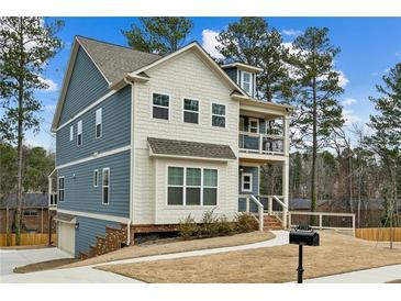 Charming two-story home featuring a blue and white color scheme, porch, and well-manicured lawn at 3119 Stonegate Sw Dr, Atlanta, GA 30331
