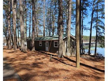 Cozy waterfront cabin nestled among trees with serene lake views and private dock access at 5400 Kings Camp Rd Se B-34, Acworth, GA 30102