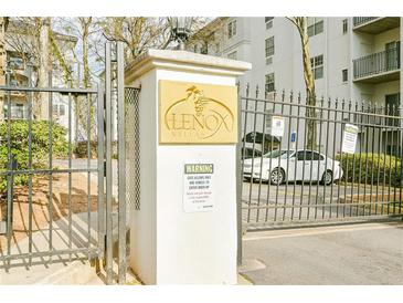 Community entrance sign at Lenox Villas with a gate and warning sign for vehicles entering the property at 970 Sidney Marcus Ne Blvd # 1208, Atlanta, GA 30324