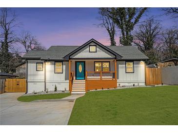 Charming craftsman-style home with a freshly landscaped lawn, updated siding, and a bright blue front door at 3470 Glenwood Rd, Decatur, GA 30032