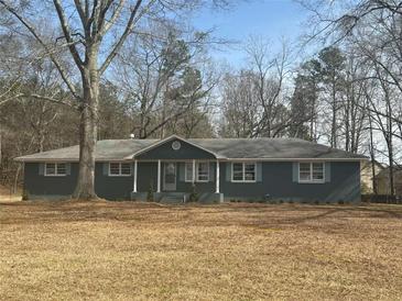 Charming single-story home with a covered front porch and a well-maintained front yard at 9588 Poston Rd, Jonesboro, GA 30238