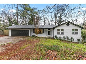 Charming renovated brick home with an attached garage and manicured lawn at 3367 Spring Meadow Ct, Tucker, GA 30084