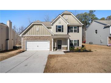 Charming two-story home featuring stone accents, neutral siding, and an attached two-car garage at 461 Charleston Pl, Villa Rica, GA 30180