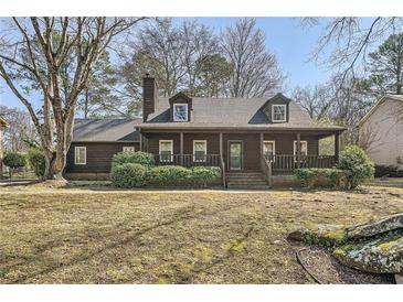 Charming single Gathering home with a cozy front porch and well maintained lawn and landscaping at 4722 Bexley Dr, Stone Mountain, GA 30083