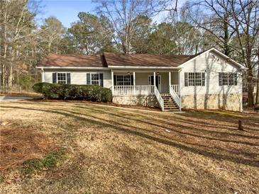 Charming single-story home featuring stone accents, a welcoming front porch, and a well-maintained lawn at 521 Country Lake Dr, Mcdonough, GA 30252