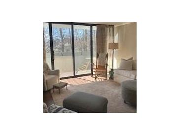 Bright living room with large sliding glass doors and comfortable seating at 3530 Piedmont Ne Rd # 3I, Atlanta, GA 30305