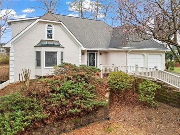 Charming home with a well-maintained yard, inviting entrance, and an attached two-car garage at 10625 Haynes Forest Dr, Alpharetta, GA 30022