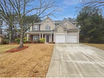 Charming two-story home with a two-car garage and a welcoming front porch in a tree-filled neighborhood at 2208 Howell Farms Nw Pt, Acworth, GA 30101