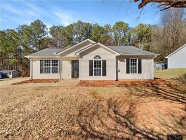 Charming single-story home featuring classic black shutters and a well-manicured lawn at 338 Thorn Thicket Dr, Rockmart, GA 30153