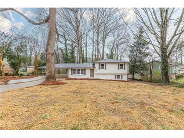 Charming split-level home featuring a covered carport and freshly painted exterior at 8483 Magnolia Dr, Jonesboro, GA 30238