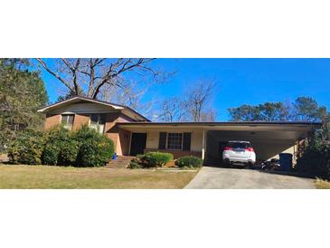 Charming single-story brick home with a convenient carport and well-maintained front yard at 4870 Welcome All Sw Rd, Atlanta, GA 30349