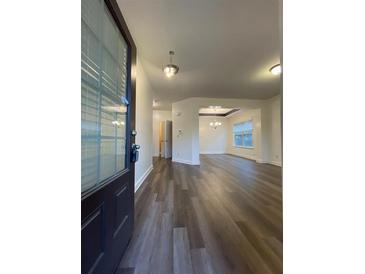 Inviting entrance with dark brown door, hardwood floors, and views into the dining room at 5928 Cobblestone Creek Cir, Mableton, GA 30126