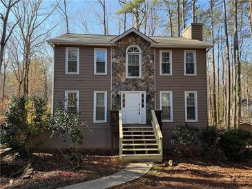 Charming two-story home with a stone facade, white trim, and a welcoming front entrance at 1007 Burton Nw Ct, Kennesaw, GA 30152