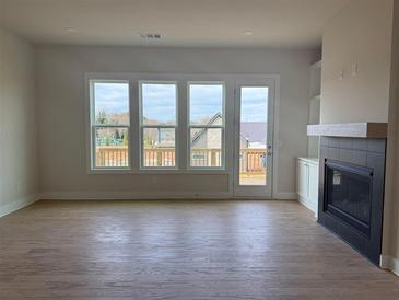 Bright living room features hardwood floors, a fireplace, and large windows with natural light at 2445 Red Maple Xing Se, Smyrna, GA 30080