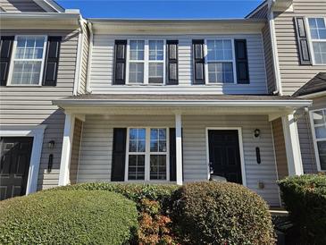 Charming townhome featuring a cozy front porch and well-maintained landscaping, creating a welcoming curb appeal at 6583 Arbor Gate Sw Dr # 10, Mableton, GA 30126