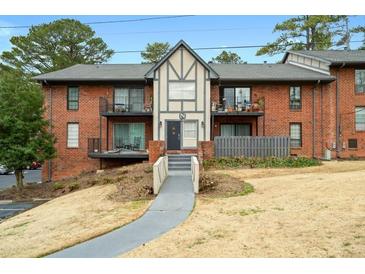 Brick apartment building featuring private balconies and well-maintained landscaping at 6851 Roswell Rd # N10, Sandy Springs, GA 30328