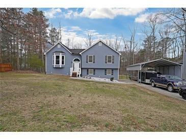 Charming two-story home with a bay window, a covered carport, and a well-manicured front yard at 41 Silverthorne Ct, Douglasville, GA 30134