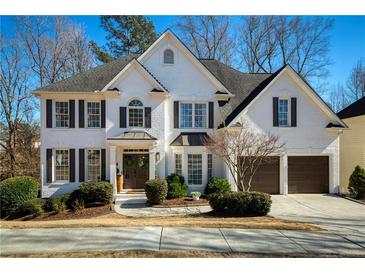 Beautiful two-story home with a brick facade, manicured landscaping, and a two-car garage at 3966 Creekview Ridge Dr, Buford, GA 30518