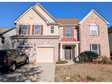 Traditional brick two-story home with a two-car garage and well-maintained lawn at 5625 Jamerson Dr, South Fulton, GA 30349