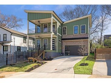 Modern two-story home with green siding, brick accents, and a two-car garage at 916 Ira Sw St, Atlanta, GA 30310