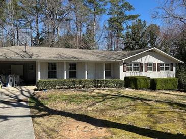 Charming single-story home with a well-manicured lawn and beautiful, neutral-colored brick at 2475 Freydale Se Rd, Marietta, GA 30067