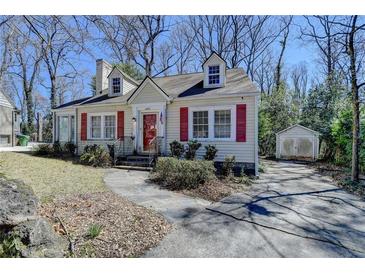 Charming home with light yellow siding, red shutters, dormer windows, and a stone walkway at 2953 Hardman Ne Ct, Atlanta, GA 30305