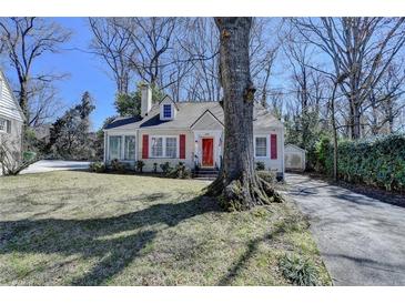 Charming bungalow-style home with a well-maintained front yard and a distinctive red door and shutters at 2953 Hardman Ne Ct, Atlanta, GA 30305