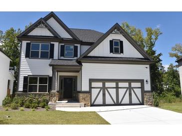 Beautiful two-story home featuring a stone-accented facade, a garage, and a well-manicured lawn at 480 Brown Dove Ln, Grayson, GA 30017