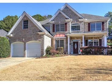 Charming brick two-story home with a well-manicured lawn and attached two-car garage at 1326 Nantahala Ne Trl, Marietta, GA 30062