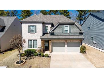 Charming two-story brick home with well-maintained landscaping and a two-car garage at 2141 Hempstead Ct, Snellville, GA 30078