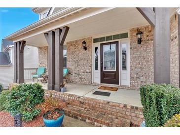 Inviting front porch with brick facade, decorative columns, and seating area at 108 Rex Ave, Canton, GA 30114
