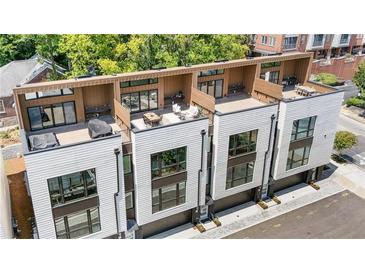 Modern townhomes with rooftop decks featuring outdoor dining and lounge areas at 622 Bellemeade Nw Ave # 2, Atlanta, GA 30318