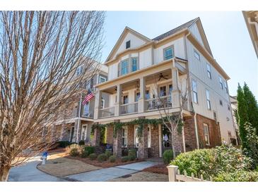 Charming two-story home with brick accents, covered porch, and manicured landscaping at 219 Dawson Dr, Woodstock, GA 30188
