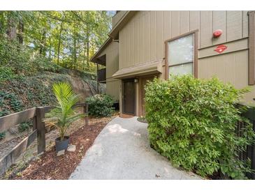 Inviting condo exterior with a well-manicured walkway leading to the front entrance and green foliage at 2707 Cumberland Se Ct, Smyrna, GA 30080
