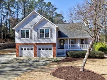 Charming two-story home with gray siding, brick accents, two-car garage and a welcoming front porch at 2157 Killian Nw Way, Kennesaw, GA 30152