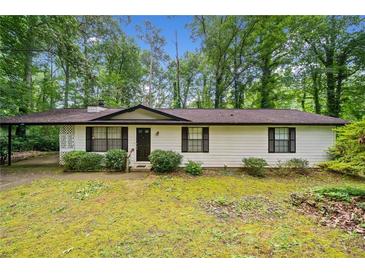 Charming single-story home with a well-maintained lawn and mature trees at 1184 Alemeda Dr, Marietta, GA 30066