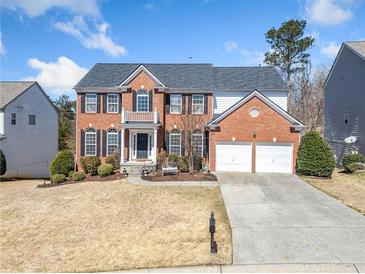 Beautiful two-story brick home with a two-car garage and manicured landscaping at 239 Sumac Trl, Woodstock, GA 30188