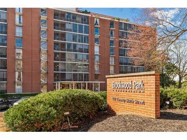 Brick condo building with large windows and a sign for Brookwood Park Condominiums at 130 26Th Nw St # 615, Atlanta, GA 30309